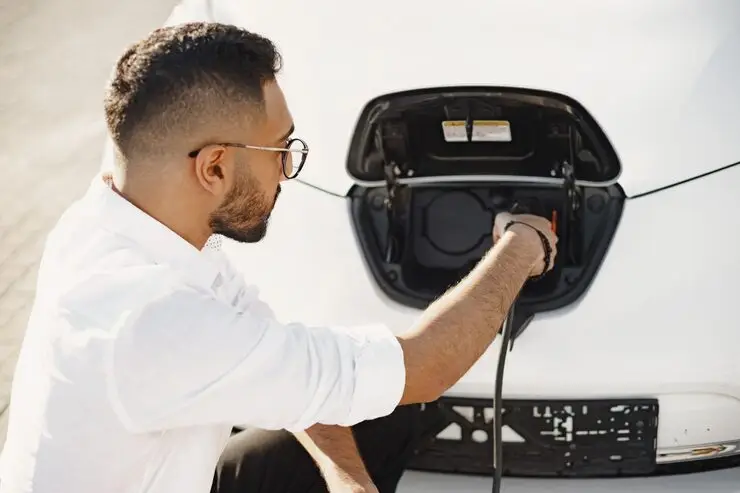 Young Adult Man Charging His Electric Car City Eco Electric Car Concept 1157 49389 - Charge Point Homes